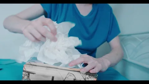 Close Up of Person Frantically Pulling Tissues from Tissue Box Stock Footage 341487035