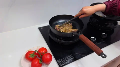 Close up of person frying lamb chops in a modern kitchen. Stock-Footage 332329024