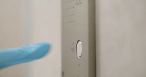 Close up of person in gloves pushing elevator call button Video stock 147395324