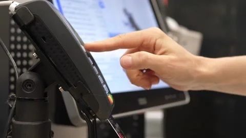 Close up of person hand inserting a credit card in the terminal and entering the Stock Footage 157056539