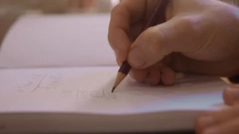 Close up of person hand solving mathematical calculations with pen on paper Video stock 344868935