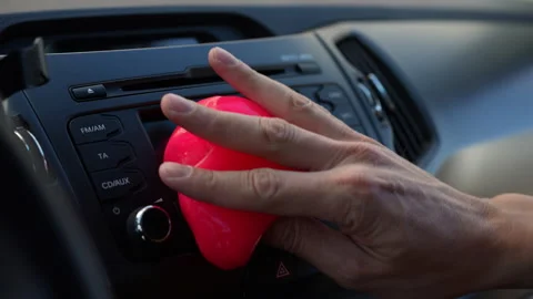 Close-up of person hand using pink cleaning gel to remove dust from car Stock-Footage 342766992