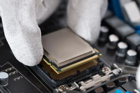 Close-up Of Person Hands Installing Central Processor In Motherboard 스톡 사진