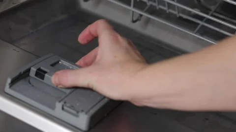 Close-up Of Person Hands Putting Dishwasher Soap Tablet In  Dishwasher Box Stock Footage 229711127