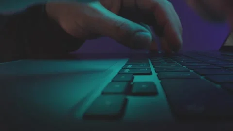 Close up of person hands typing fast on laptop keyboard in dark room with n.. Stock Footage 337599297