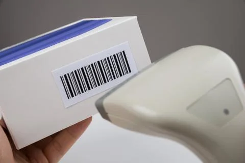 Close-up Of Person Hands Using Barcode Scanner To Scan A Barcode On A Box Stock Photos