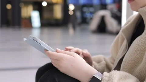 Close-up of person holding and using digital tablet in indoor setting Stock Footage 341995782