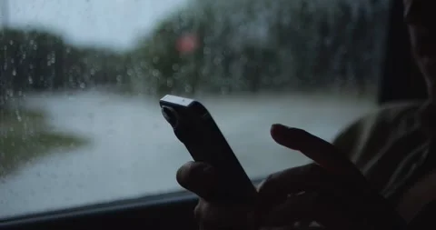 Close-Up Of Person Holding Smartphone Inside Car During... Stock Footage 332075321