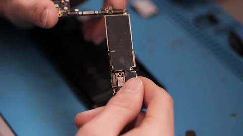 Close person holds audio processor with pincers in workshop Stock Footage 104656190