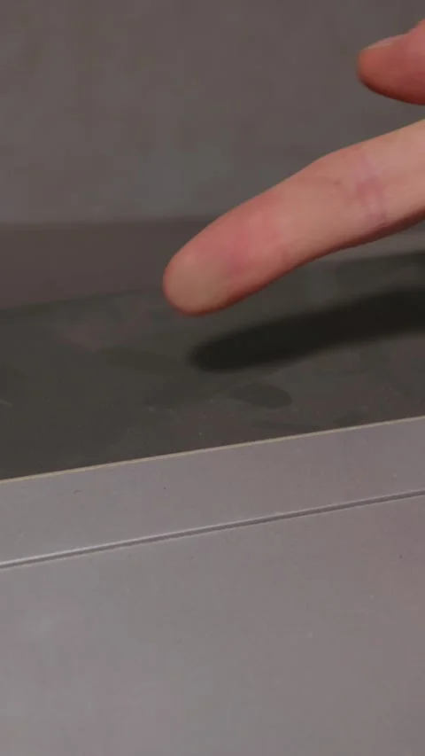 Close Up of a Person Index Finger Pointing at a Dark Grey Flat Surface Video stock 335635948