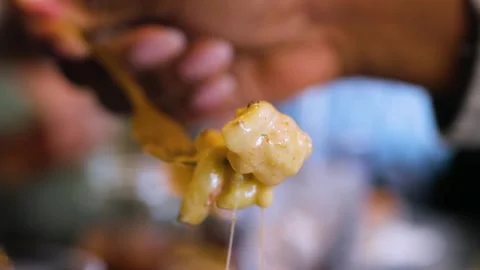 Close up of person lifting cheesy macaroni and cheese with fork in restaurant Stock-Footage 337627134