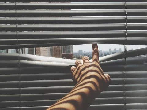 Close-Up Of Person Looking Through The Window Stock Photos