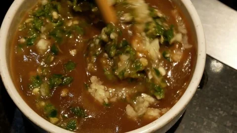 Close up of person mixing spicy garlic dipping sauce in a bowl Video stock 336229953