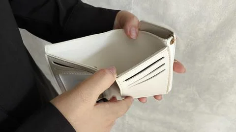 Close-up person opening empty wallet showing broke financial in debt from ove Stock Photos