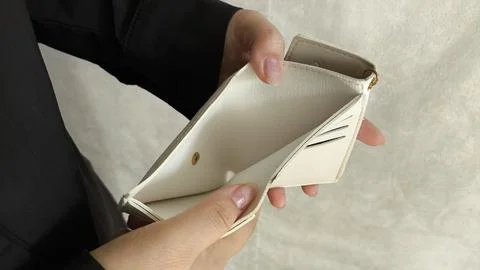 Close-up person opening empty wallet showing broke financial in debt from ove Stock Photos