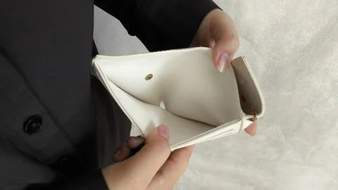 Close-up person opening empty wallet showing broke financial in debt from ove Stock Photos