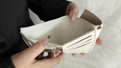 Close-up person opening empty wallet showing broke financial in debt from o.. Stock Photos
