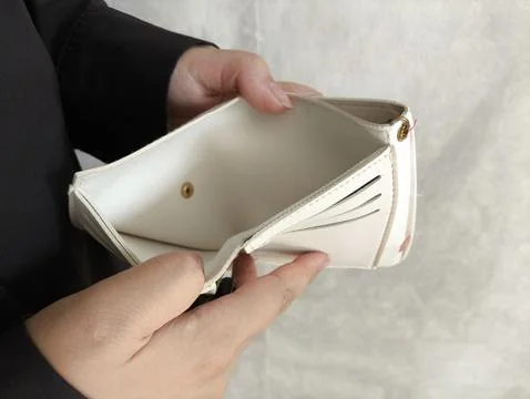 Close-up person opening empty wallet showing broke financial in debt from ove Stock Photos