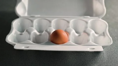 Close-up of person opening tray with one egg 库存影片 338290305