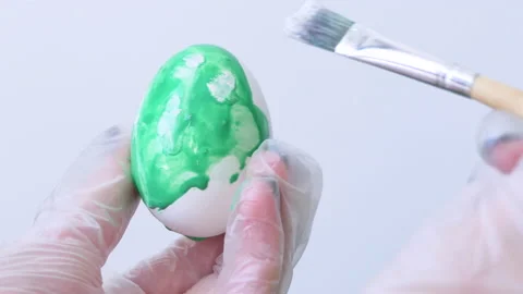 Close-up of a person painting Easter eggs with a special brush Stock Footage 172139520