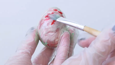 Close-up of a person painting Easter eggs with a special brush Stock Footage 172144742
