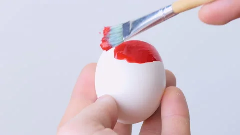 Close-up of a person painting Easter eggs with a special brush Stock Footage 172145564
