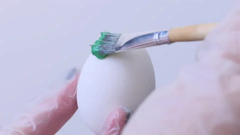 Close-up of a person painting Easter eggs with a special brush Stock Footage 172146649