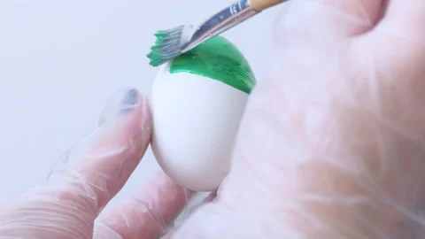 Close-up of a person painting Easter eggs with a special brush Stock Footage 172148598
