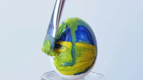 Close-up of a person painting Easter eggs with a special brush Stock Footage 172188313