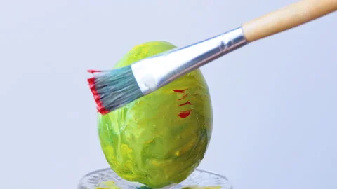 Close-up of a person painting Easter eggs with a special brush Stock Footage 172189731