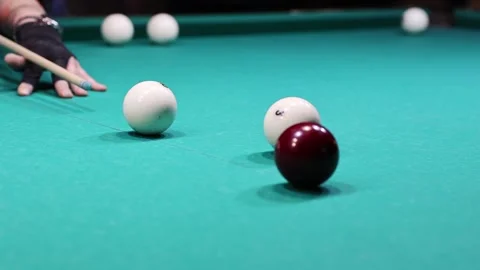 A close-up of a person playing Russian pyramid billiards, showing cue stick Stock Footage 315405315