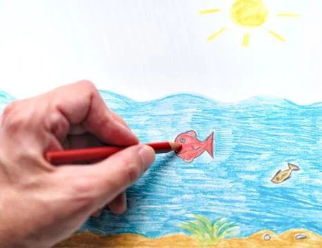 A close-up of a person practicing art therapy by coloring a simple fish Stock Photos