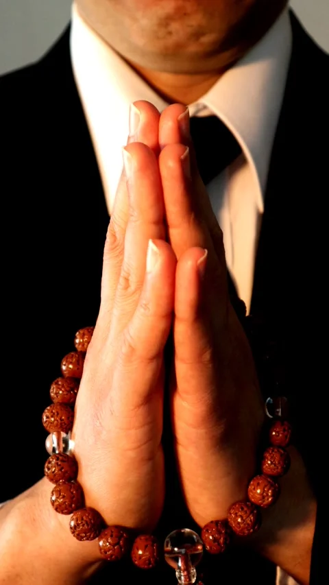 Close-up of a person praying at a funeral. Video stock 336036564