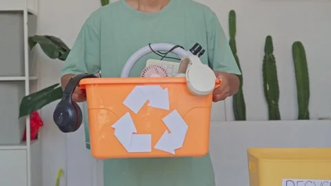 Close up of person presenting bin full of old electronics and tech devices for Stock Footage 340576493