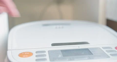 Close up person pressing and open electric rice cooker with smoke from hot steam Stock Footage 147064712