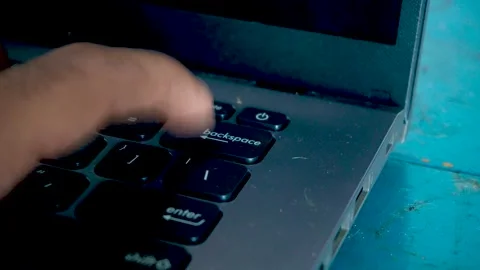 Close up of a person pressing the backspace key repeatedly on a computer la.. Stock Footage 340489660