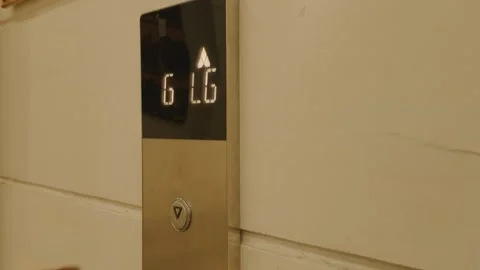 Close up of a person pressing the down button on an elevator panel. Stock Footage 343415409