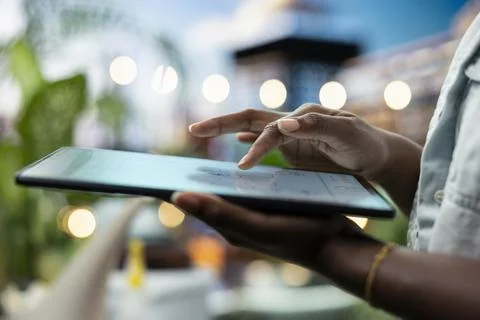 Close up of person on rooftop terrace using smart home gardening app on tablet Stock Photos