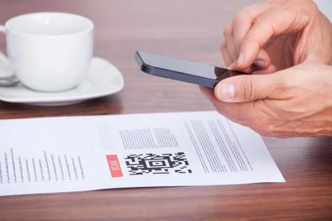 Close-up of a person scanning barcode using cellphone 写真素材