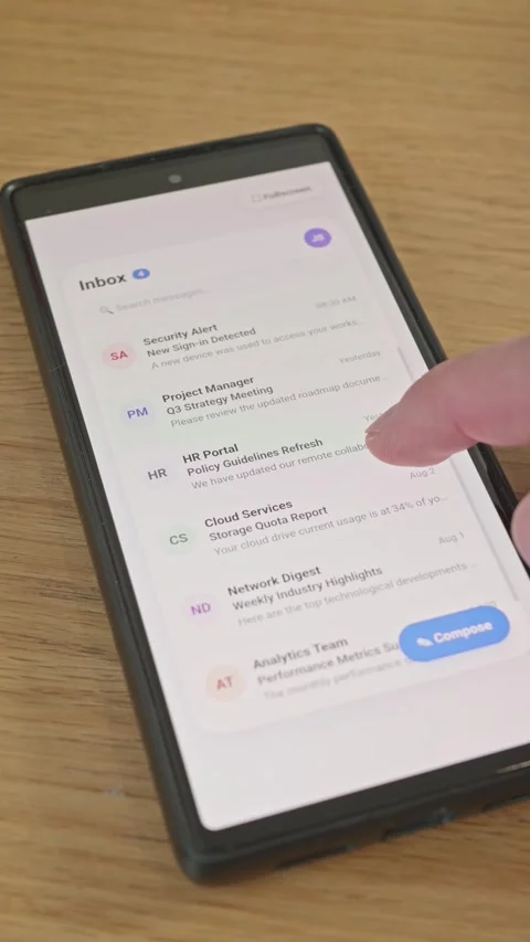 Close-up of person scrolling email inbox on smartphone displaying work Stock Footage 341860592