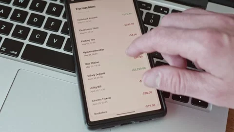 Close-up of a person scrolling through financial transactions list on a mobile 스톡 동영상 337998124