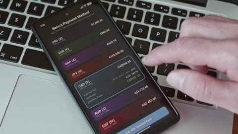 Close-up of a person selecting a multi-currency virtual card on a smartphone Stock-Footage 337998448