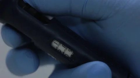 Close up of a person setting volume on precision micro pipette Stock Footage 75846397