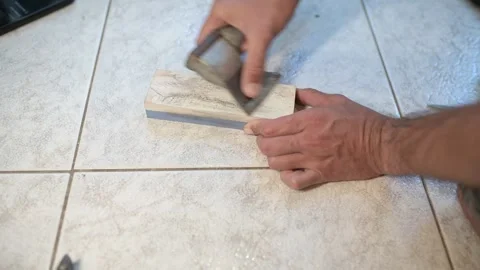 Close-up of a person sharpening an axe blade on a whetstone, careful hand work Stock Footage 318599827