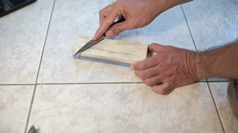 Close-up of a person sharpening a knife on a whetstone, precise hand movements Stock Footage 318599370