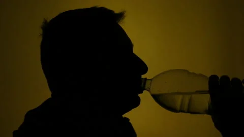 Close-up of a person in silhouette drinking Stock Footage 171728253