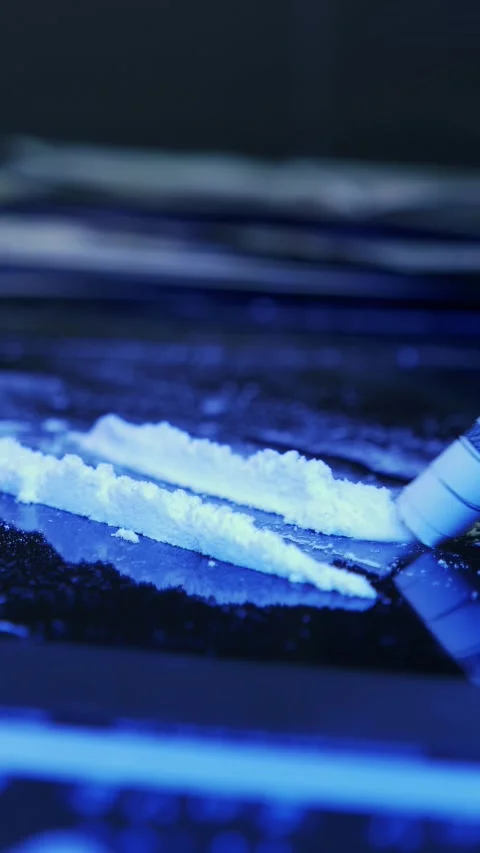 Close up of person is snorting line of white drug powder. Vertical video 動画素材 335756390