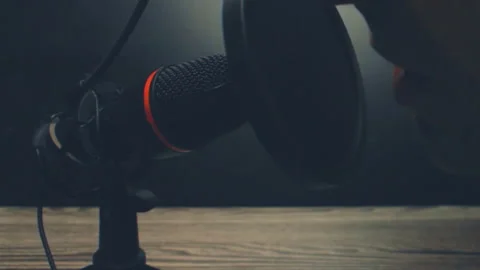 Close Up Person Speaking Into Microphone In Dark Room Podcast Stock Footage 329375134