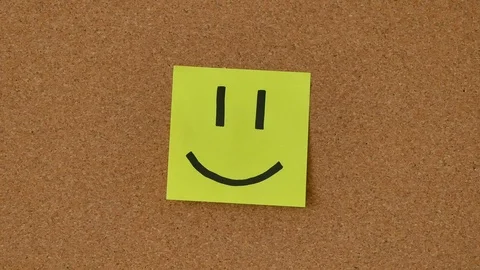 Close-up of the person sticking notes with smiles on the board. Sad and Happy Stock Footage 106076250