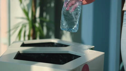 Close-up. A person throws a plastic bottle into a waste sorting container. Stock Footage 236901996